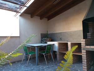 a patio with a table and two chairs at Casa rural Puchero y Manta in Alcudia de Veo