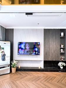 a living room with a flat screen tv on a wall at LaLa Penthouse in Hue