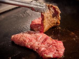 a piece of meat being cooked on a pan at Irago Ocean Resort in Tahara