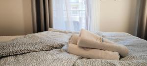 a bed with two pillows on it with a window at Central Apartments Neptun Park 1 & Parking in Gdańsk