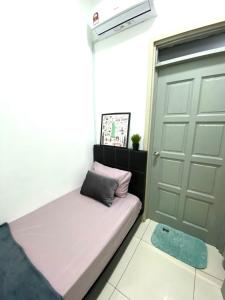a bed in a room with a door and a window at MiriTimesSquare DAJ#3 FREE WiFi in Miri