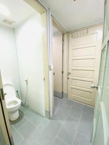 a bathroom with a toilet and a sliding door at MiriTimesSquare DAJ#3 FREE WiFi in Miri