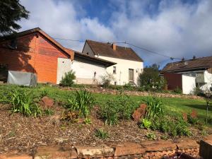 a house with an orange and white house at Traumhaftes Studioappartement in Wadern