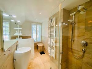 a bathroom with a shower and a toilet and a sink at Ferienhaus am Lotsenstieg 6 in Karlshagen +23 photos