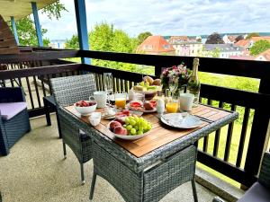 a table with bowls of fruit on a balcony at Ostsee-Fördeblick in Laboe