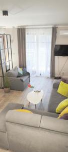 a living room with a couch and a table at Central Apartments Neptun Park 1 & Parking in Gdańsk