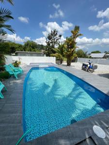 a large blue swimming pool with a person on a motorcycle at A famosa resort villa 1054 in Kampong Alor Gajah