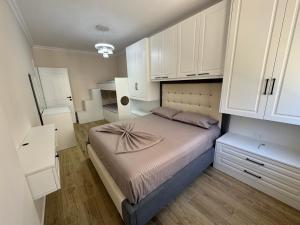 a small bedroom with a bed and white cabinets at GOLEM Best Apartment in Golem