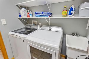 a laundry room with a washer and dryer at 2067 Duck Days Soundfront w Pier in Duck