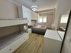 a small bedroom with a bed and a desk at GOLEM Best Apartment in Golem