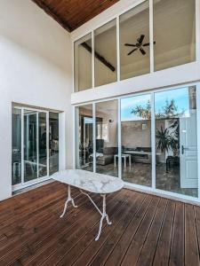 a living room with a bench on a wooden floor at Maison avec cour et parking clos in Fère-en-Tardenois
