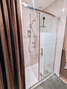 a shower with a glass door in a bathroom at Maison avec cour et parking clos in Fère-en-Tardenois +9 photos