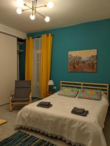a bedroom with a bed with blue walls and a chair at lake dreams in Verbania
