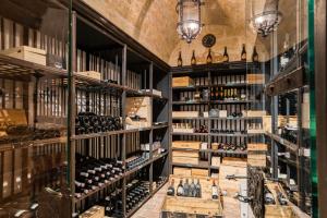 a wine tasting room with lots of wine bottles at Hotel Alpen-Royal in Jerzens