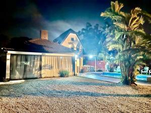 a house with a palm tree in front of it at A famosa resort villa 1054 in Kampong Alor Gajah