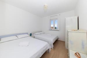 Postel nebo postele na pokoji v ubytování Penthouse Ugljan by Belmont Realty