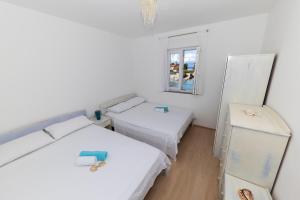 Postel nebo postele na pokoji v ubytování Penthouse Ugljan by Belmont Realty