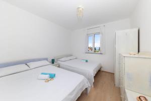 Postel nebo postele na pokoji v ubytování Penthouse Ugljan by Belmont Realty