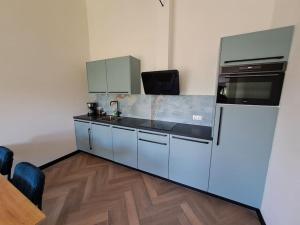 a kitchen with a refrigerator and a sink at De Platwever 3C in Zelhem +19 photos