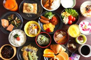 a table with many plates of food on it at Hotel Hokke Club Niigata Nagaoka in Nagaoka