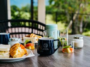 a table with a cup of coffee and a plate of food at Setouchi Resort Villa - Vacation STAY 07952v in Takekara