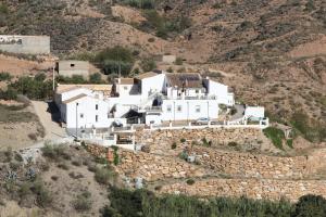 a large white house on top of a hill at Rambla Retreats Apartment Naranja in a beautiful location with pool & hot tub in Oria