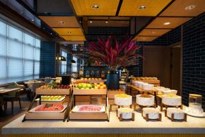 a restaurant with a display of fruits and vegetables at SSAW Boutique Hotel Hangzhou Chengjun in Hangzhou