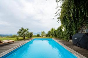 a swimming pool in a villa with a garden at Schmolti's Chalet - Wellness über Graz in Zösenberg