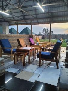 a group of chairs and tables on a patio at Grace Resort in Homa Bay