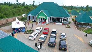 a group of cars parked in a parking lot in front of a building at Grace Resort in Homa Bay