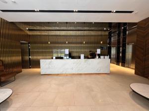 a lobby with a reception desk in a building at Wink Hotel @ Bugis in Singapore