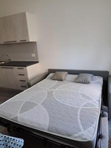 uma cama grande num quarto com uma cozinha em Monolocale 2\4 posti presso Residence la Spiaggia em Marotta
