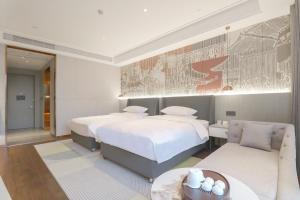 Tempat tidur dalam kamar di Anxi Huiting Hotel