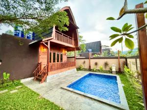 a house with a swimming pool in the yard at Nemuru Villa Ubud Anyer in Anyer