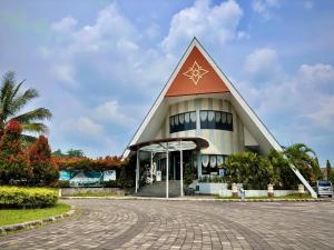 a large building with a pointed roof at Nemuru Villa Ubud Anyer in Anyer