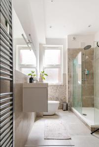 a bathroom with a sink and a shower at Blue Valley House in London