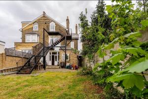 an exterior view of a house with a spiral staircase at Blue Valley House in London