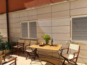 a table and chairs on a patio at Apartment Golden Sun in Dramalj
