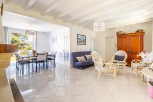 een woonkamer met een blauwe bank en stoelen bij Villa de la mer - Bretignolles in Brétignolles-sur-Mer +13 foto's