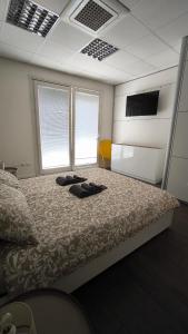 a bedroom with a bed with two shoes on it at Eveve's House in Parma
