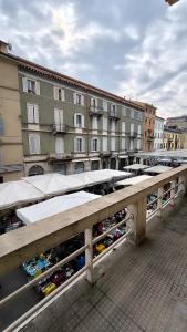 a row of tables with umbrellas in front of buildings at Eveve's House in Parma