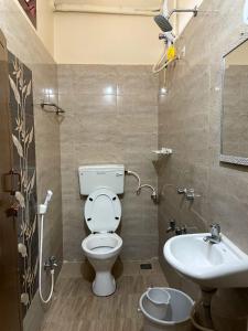 a bathroom with a toilet and a sink at Paradise Sunrise Beach Villa in Kottakupam