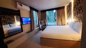 a hotel room with a large bed and a tv at The Life Style Lodges opp Centaurus Mall in Islamabad