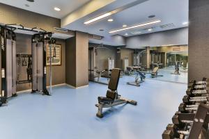 a gym with several treadmills and exercise machines at Kings Park Hotel in Podgorica
