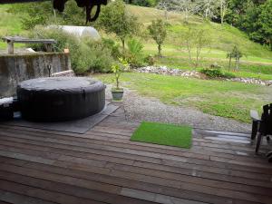 a large tire sitting on top of a wooden deck at Location en Pré montagne pyrénéenne in Saleich