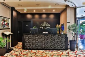 a lobby of a kings park hotel with a bar at Kings Park Hotel in Podgorica