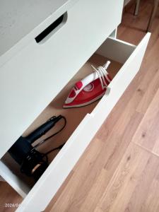 a desk with a red phone in a drawer at Antwerpen OLIVIA Apartments in Antwerp
