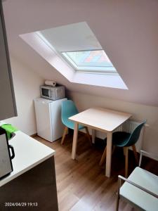 a kitchen with a skylight and a table and chairs at Antwerpen OLIVIA Apartments in Antwerp