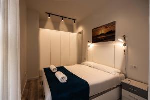 מיטה או מיטות בחדר ב-Apartamentos Turísticos Gran Vía