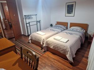 two beds in a small room with at Hostel-F in Gjakove